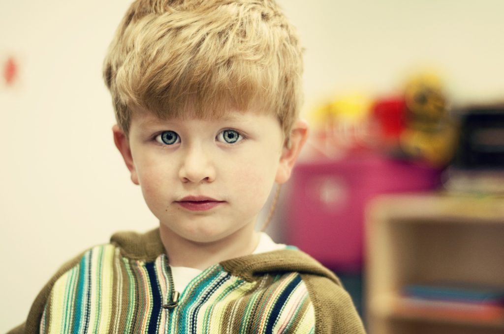 Young boy with cochlear implants