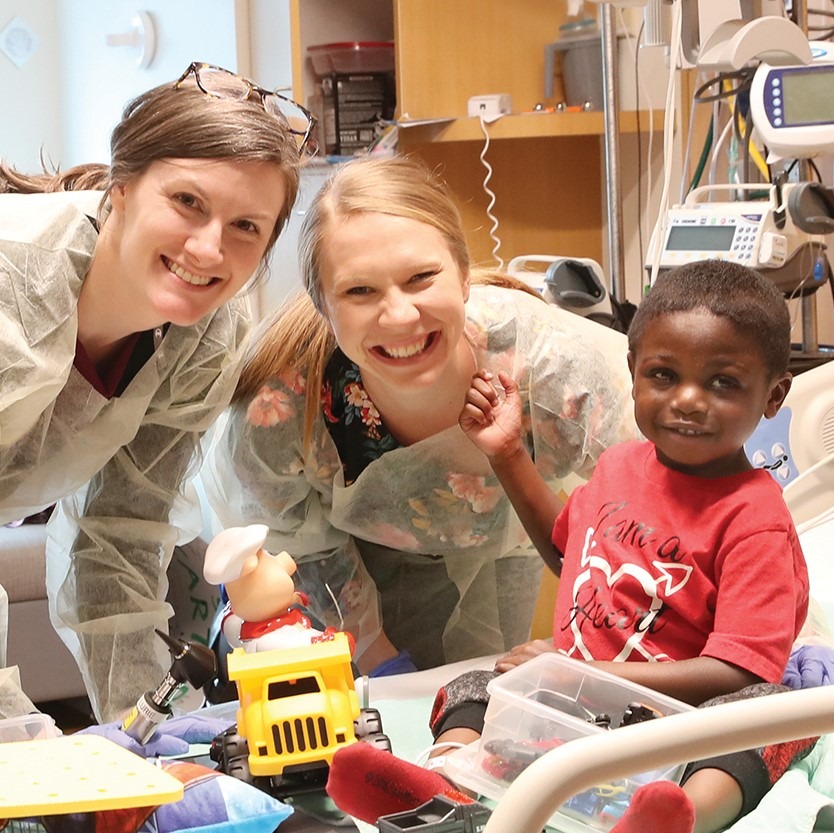 Carter Williams, 3 years old with Audiologists Kathleen Colella (left) and Susan Reynolds (center);